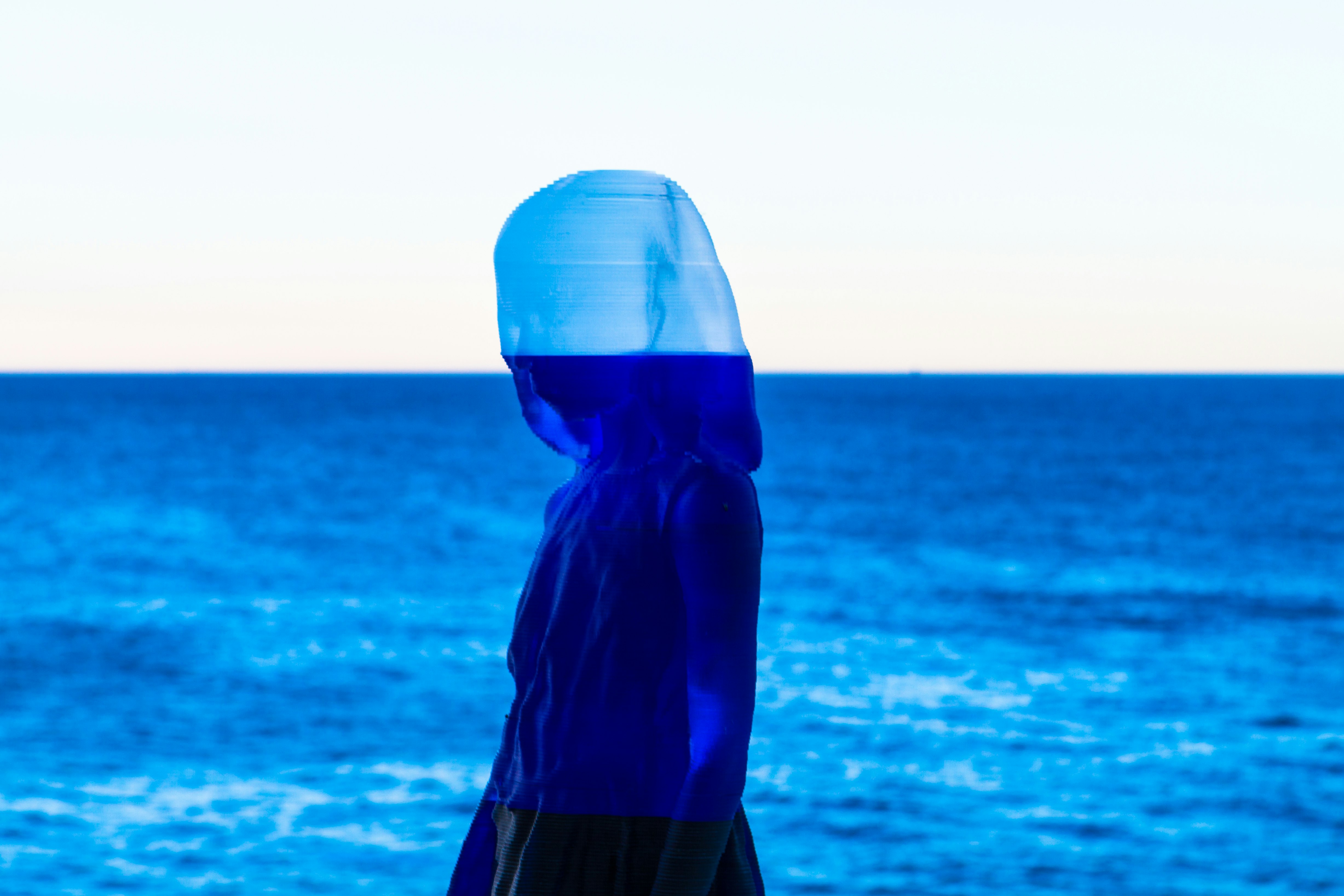 painting of woman and calm ocean